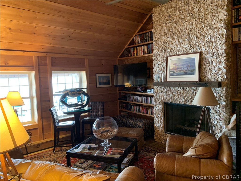 1167 Johns Neck Road Weems, VA 22576 - Photo 21 of 48 a living room with furniture a flat screen tv and a fireplace