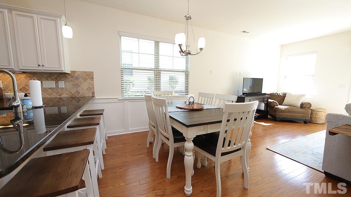 6414 Swatner Drive Raleigh, NC 27612 - Photo 5 of 21 a view of a dining room with furniture window and wooden floor