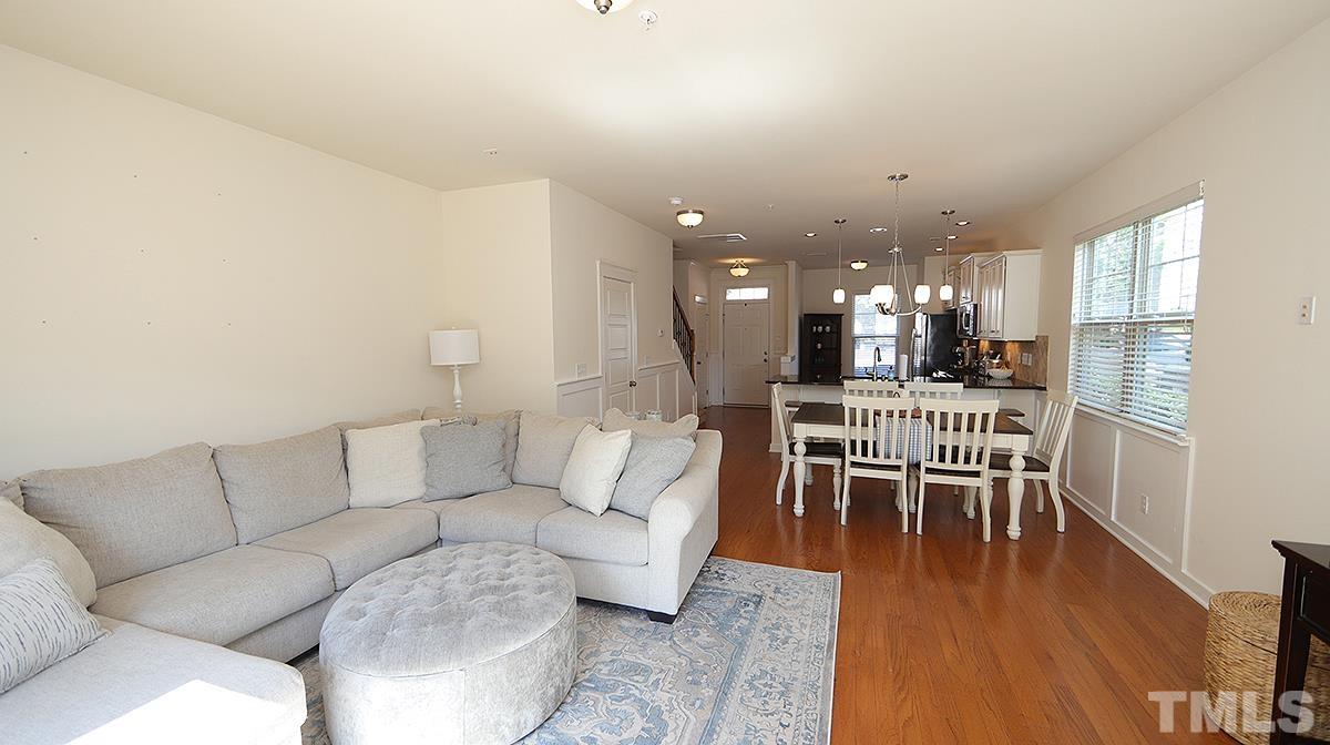 6414 Swatner Drive Raleigh, NC 27612 - Photo 21 of 21 a living room with furniture and a dining table with wooden floor