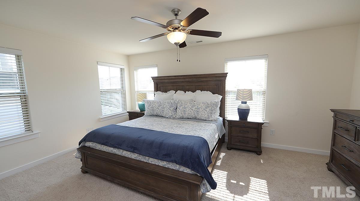 6414 Swatner Drive Raleigh, NC 27612 - Photo 7 of 21 a bedroom with a bed and window