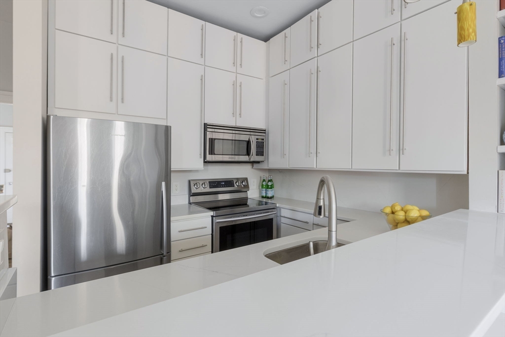 27 Concord Square, Unit 3 Boston, MA 02118 - Photo 2 of 15 a kitchen with stainless steel appliances a refrigerator a stove a microwave and cabinets