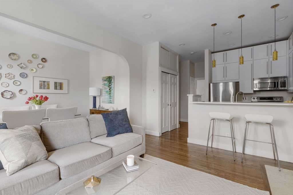 27 Concord Square, Unit 3 Boston, MA 02118 - Photo 4 of 15 a living room with furniture and kitchen view