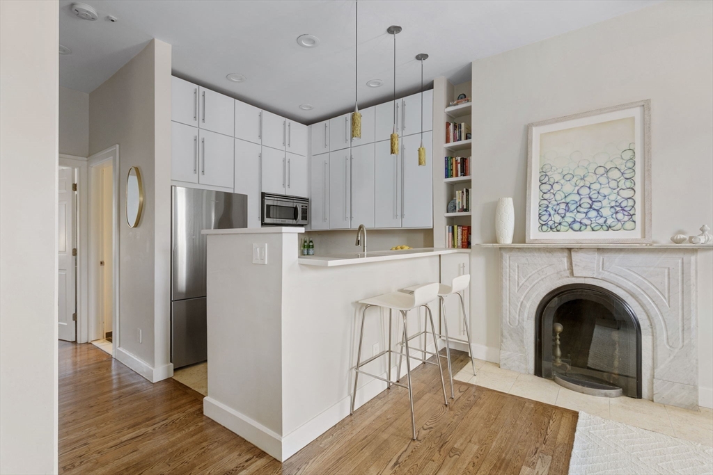 27 Concord Square, Unit 3 Boston, MA 02118 - Photo 5 of 15 a view of kitchen with sink a refrigerator and a stove