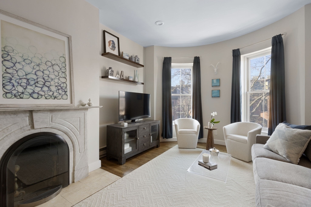 27 Concord Square, Unit 3 Boston, MA 02118 - Photo 6 of 15 a living room with furniture a flat screen tv and a fireplace