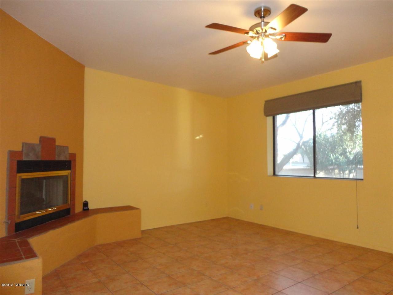 1429 North Bank Swallow Road Green Valley, AZ 85614 - Photo 20 of 34 a view of a livingroom with a chandelier fan and a fireplace