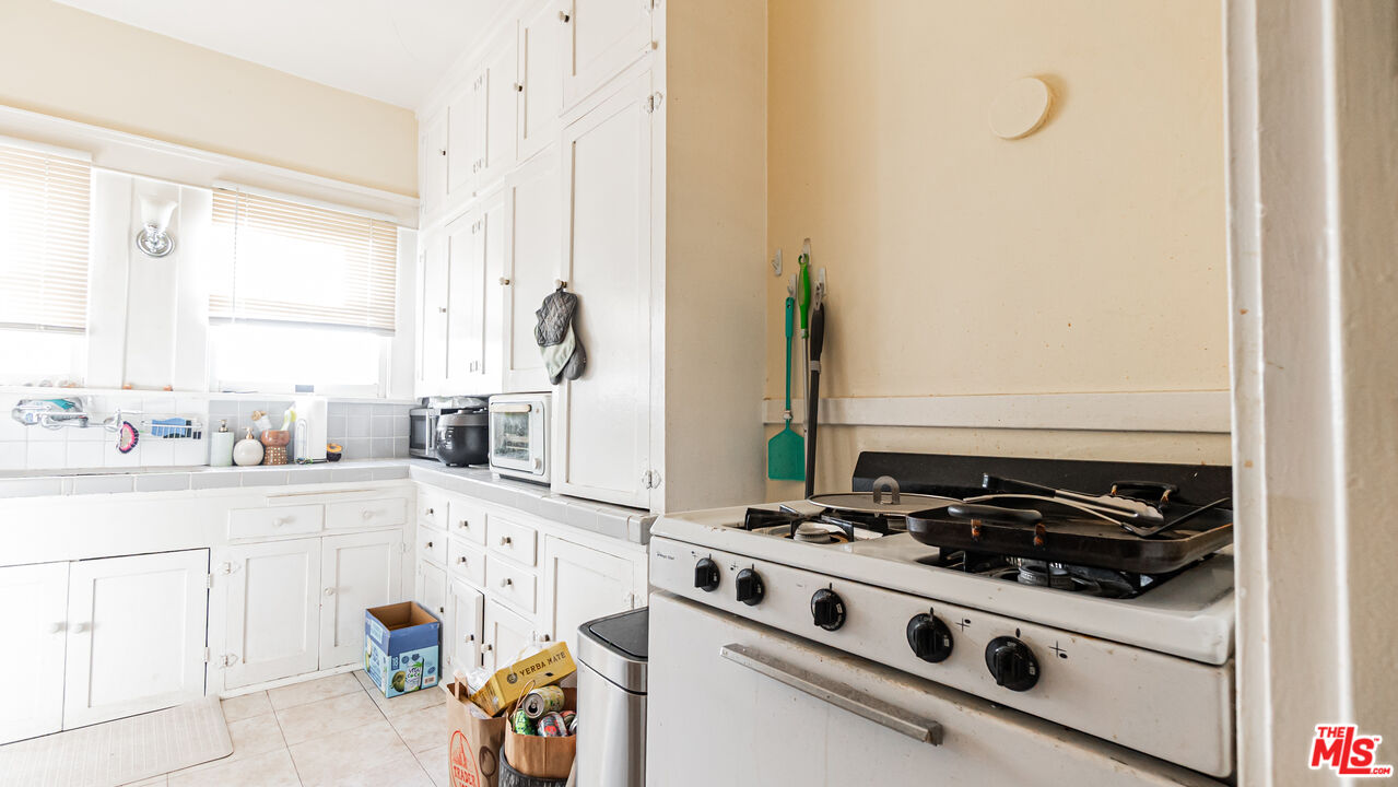 735 Locust Avenue Long Beach, CA 90813 - Photo 15 of 46 a kitchen with a stove and a white refrigerator