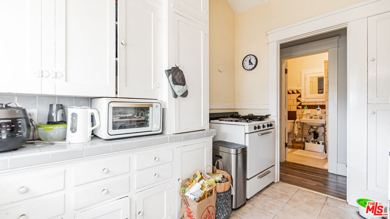 735 Locust Avenue Long Beach, CA 90813 - Photo 17 of 46 a kitchen with a refrigerator and a stove