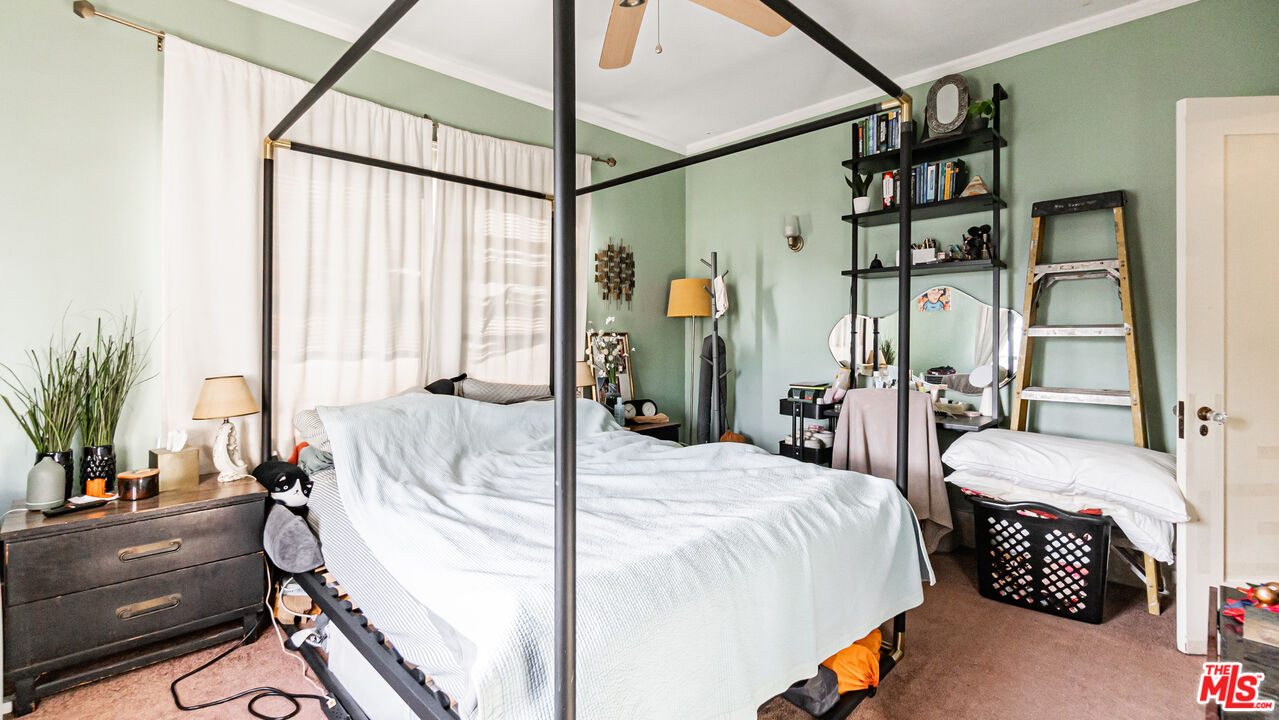 735 Locust Avenue Long Beach, CA 90813 - Photo 25 of 46 a bedroom with a bed and a chandelier