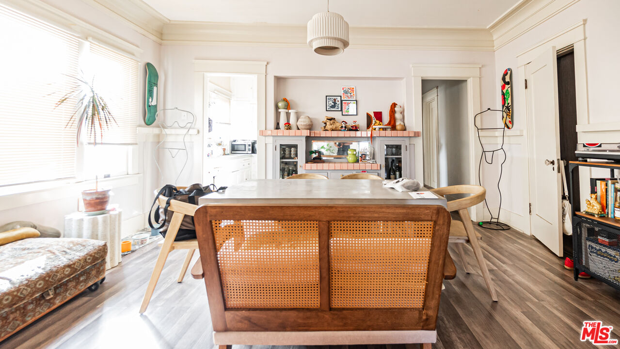 735 Locust Avenue Long Beach, CA 90813 - Photo 10 of 46 a living room with furniture a flat screen tv and a floor to ceiling window