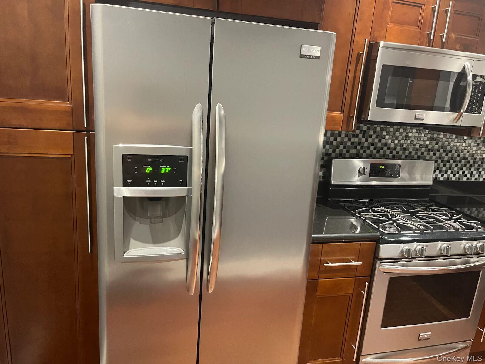 1270 White Plains Road, Unit 2 Bronx, NY 10472 - Photo 1 of 9 a kitchen with a refrigerator and a stove top oven