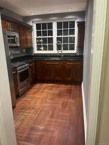 a kitchen with a stove and a refrigerator