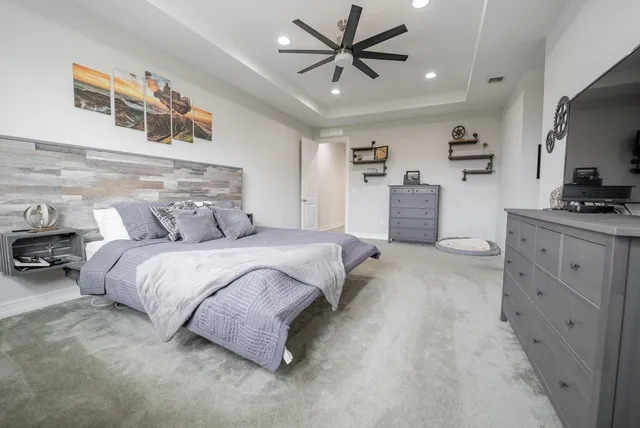 a bedroom with a bed dresser and a window