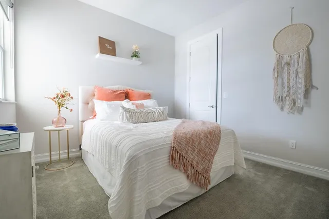 a bedroom with a bed and two windows