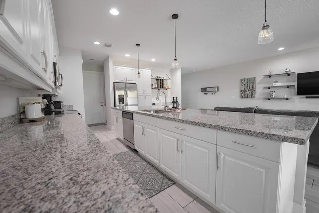 a large kitchen with a table and chairs