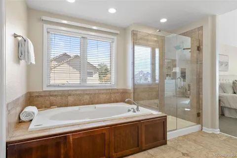 a bathroom with a tub a sink and a shower