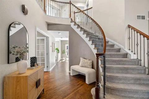 a view of entryway and hall with wooden floor