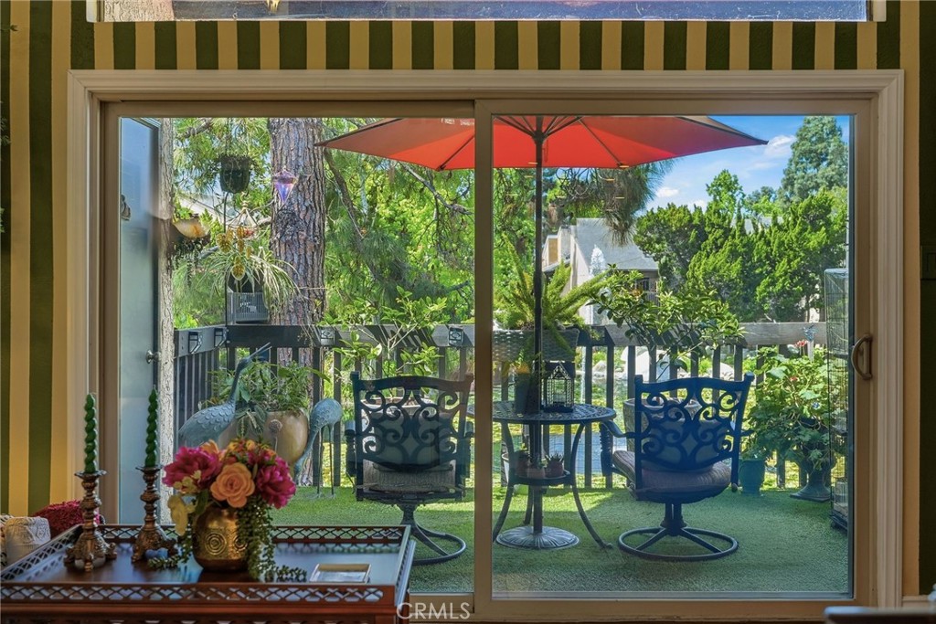 7890 East Spring Street, Unit 2L Long Beach, CA 90815 - Photo 8 of 47 a building view with a garden space