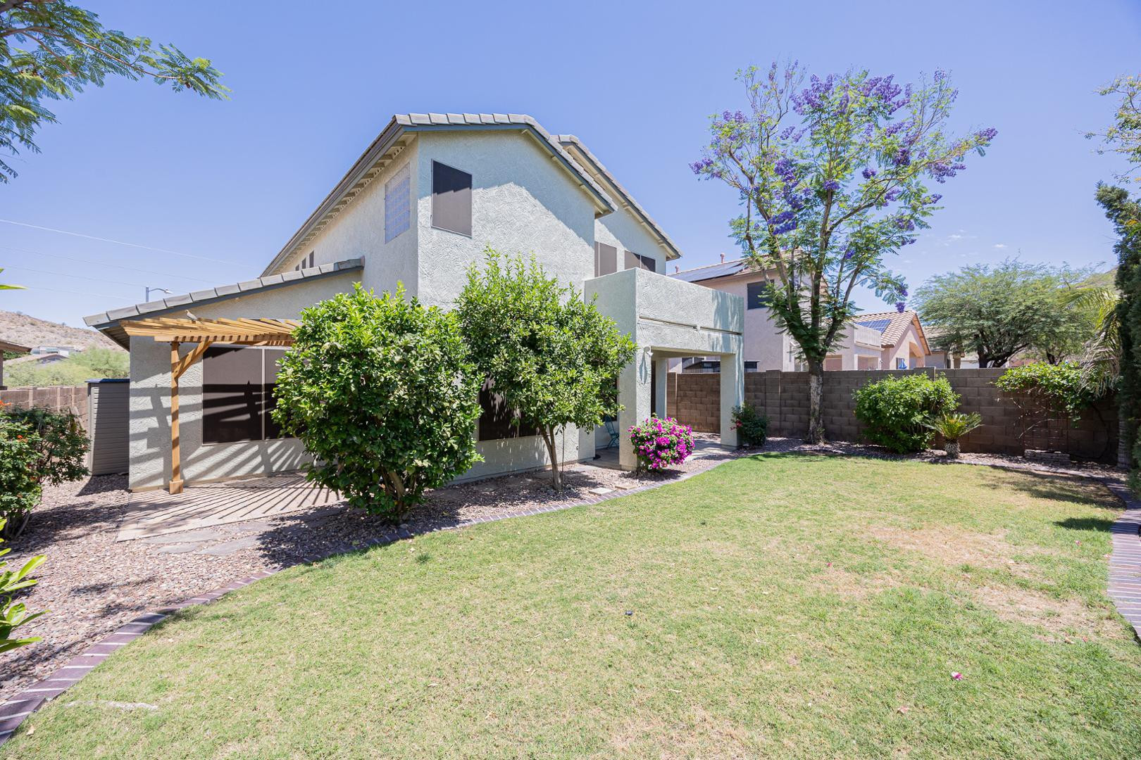 6539 West Jomax Road Phoenix, AZ 85083 - Photo 35 of 39 a front view of a house with a yard and garage