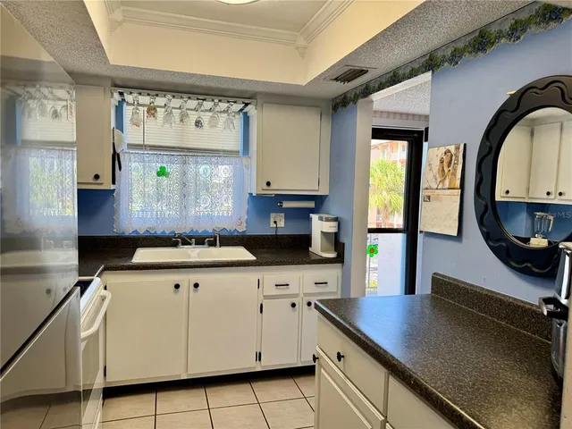 a kitchen with stainless steel appliances granite countertop a sink and cabinets