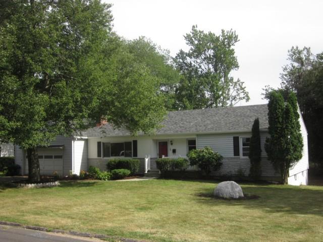 29 Meadow Road Trumbull, CT 06611 - Photo 1 of 1 a front view of a house with a garden and trees