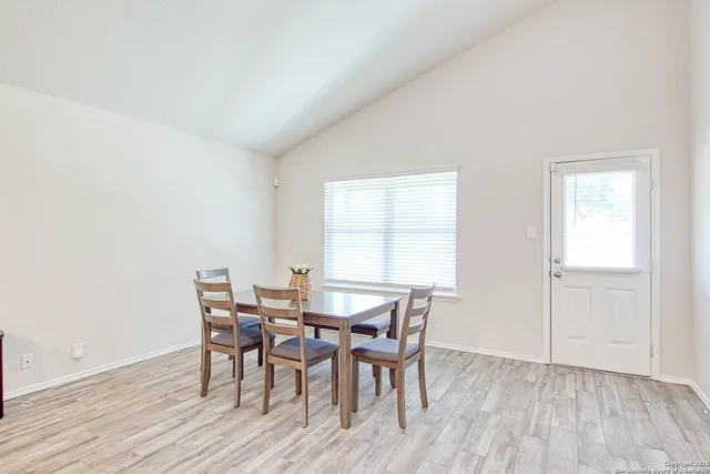 a view of a dining room with furniture and wooden floor