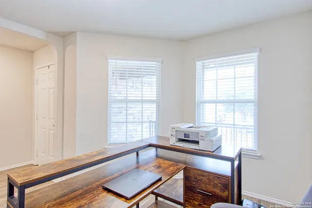 a living room with a bed and a window