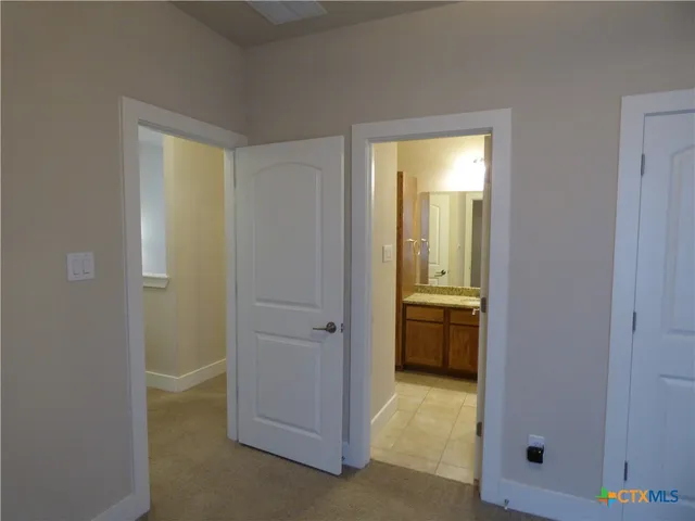 a bathroom with a granite countertop sink a toilet and shower