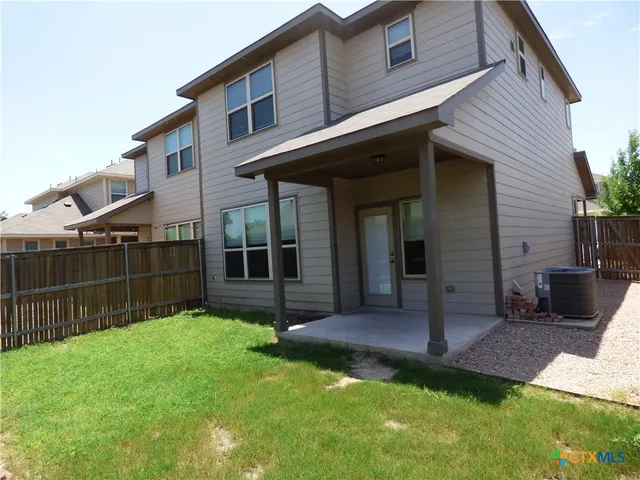 a view of path along with yard and car parked