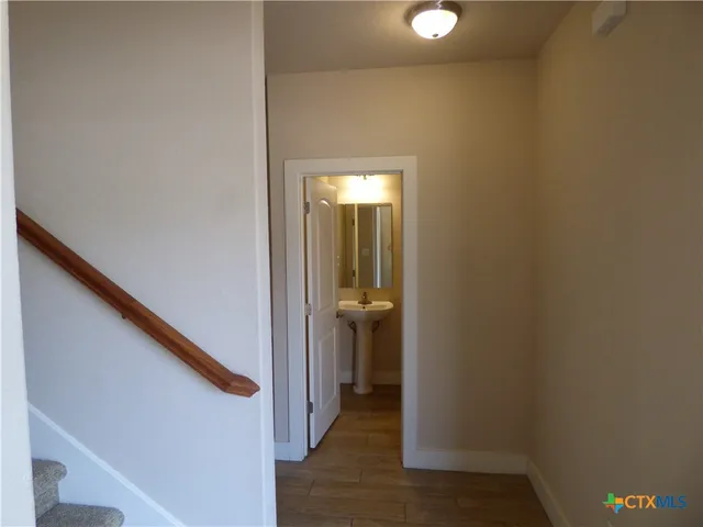 a white toilet sitting next to a bathroom sink