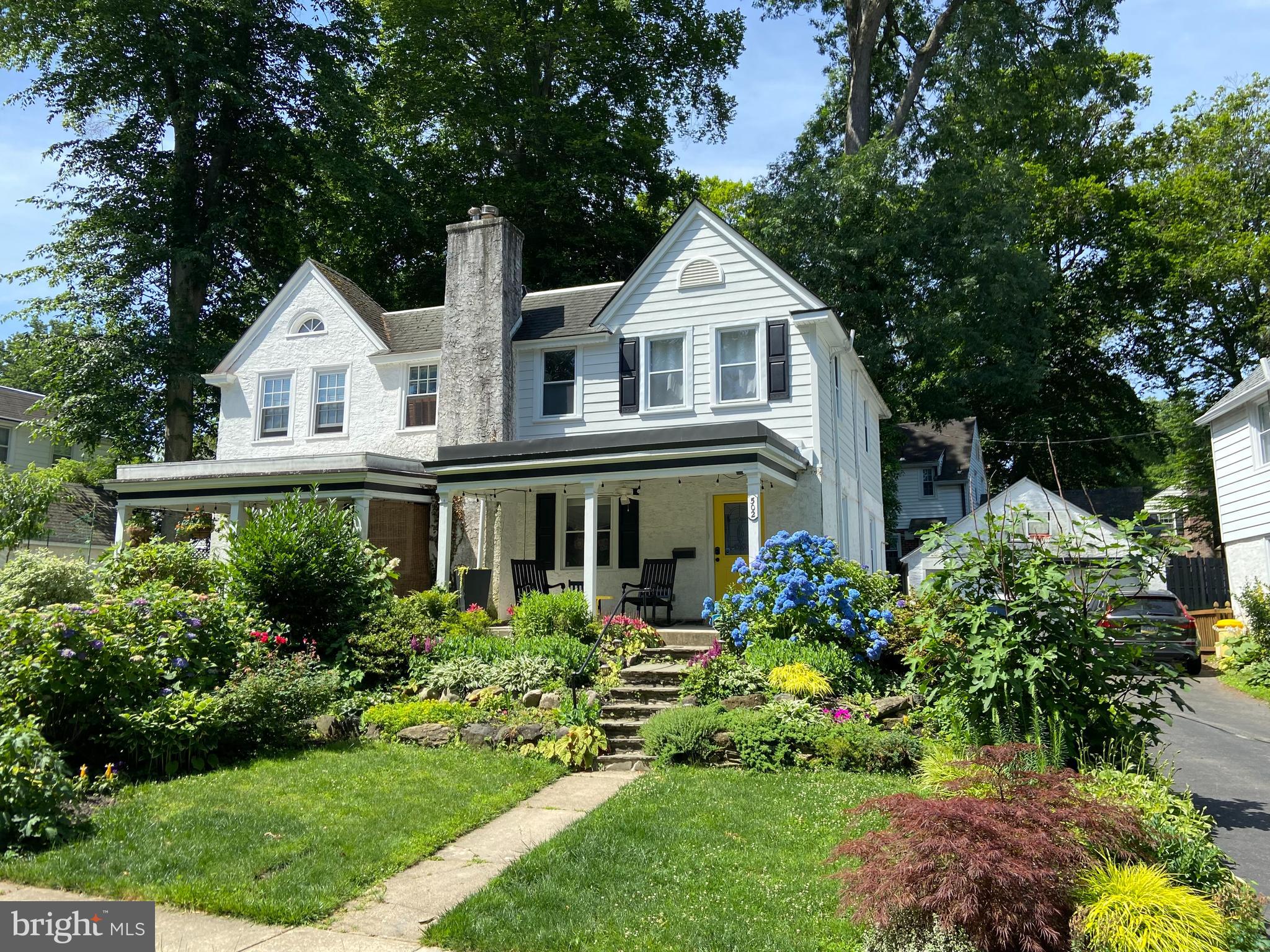 502 Beechwood Lane Narberth, PA 19072 - Photo 34 of 39 a front view of a house with a yard and a garden