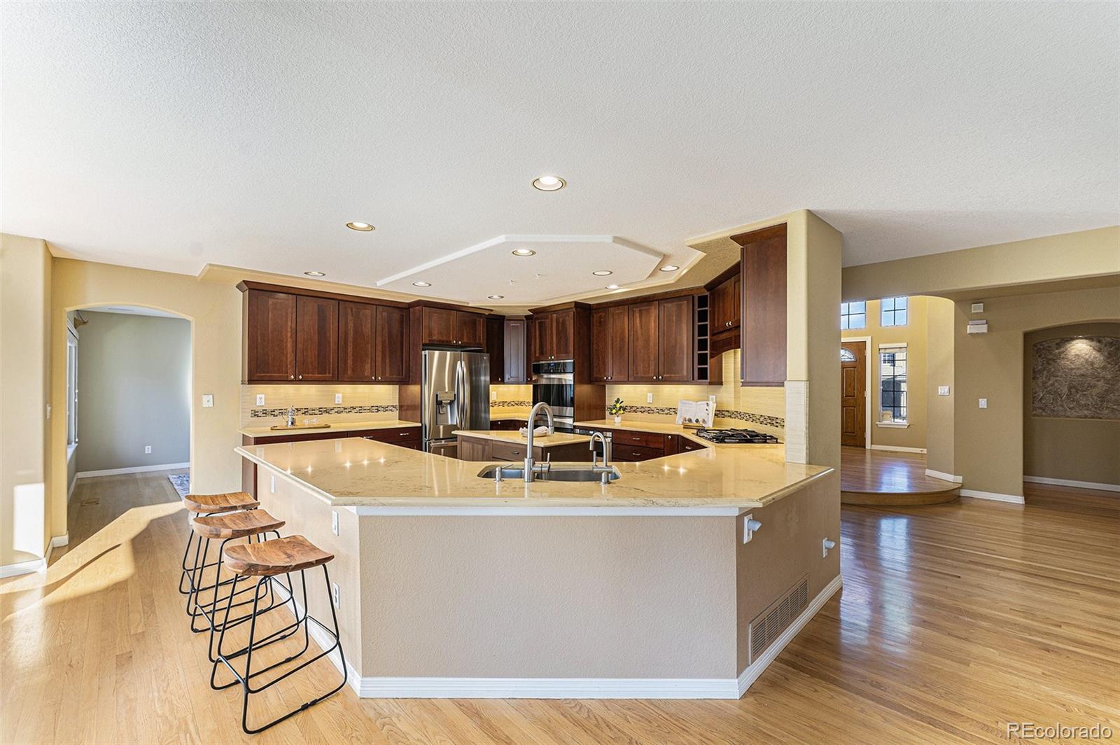 3042 Wyecliff Way Highlands Ranch, CO 80126 - Photo 11 of 40 a view of a kitchen with kitchen island stainless steel appliances a sink and cabinets