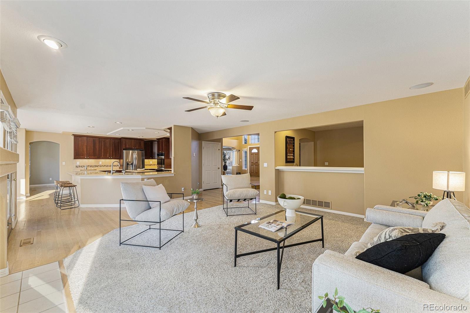3042 Wyecliff Way Highlands Ranch, CO 80126 - Photo 13 of 40 a living room with furniture and a flat screen tv