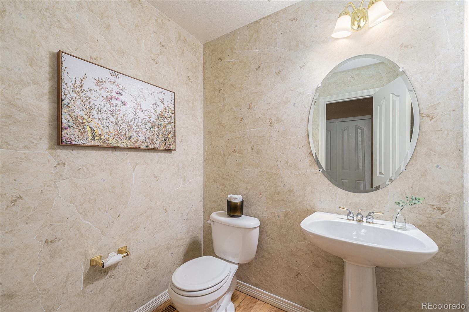 3042 Wyecliff Way Highlands Ranch, CO 80126 - Photo 14 of 40 a bathroom with a toilet a sink and mirror