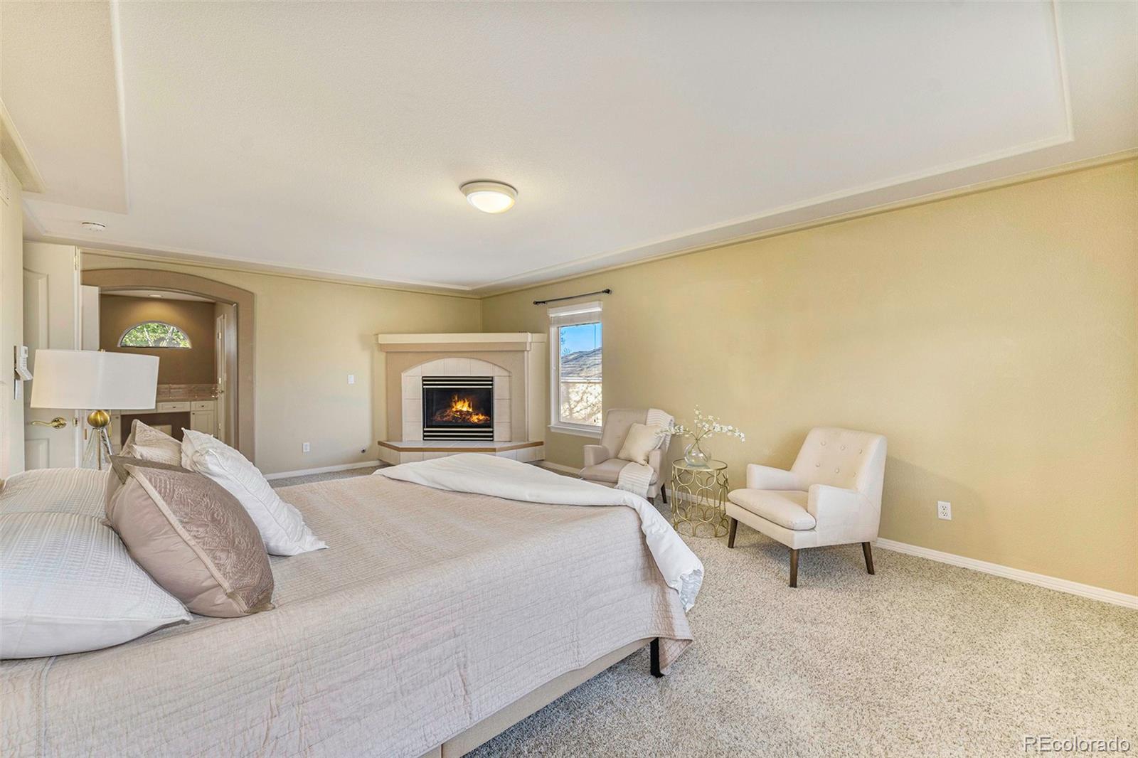 3042 Wyecliff Way Highlands Ranch, CO 80126 - Photo 18 of 40 a bedroom with a bed and a chair