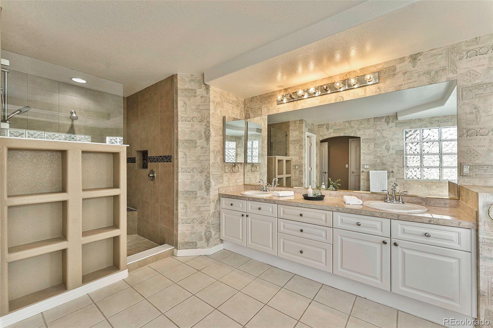 3042 Wyecliff Way Highlands Ranch, CO 80126 - Photo 20 of 40 a spacious bathroom with a granite countertop sink mirror and cabinets