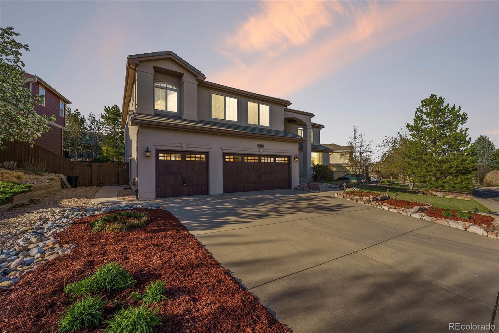 3042 Wyecliff Way Highlands Ranch, CO 80126 - Photo 2 of 40 a front view of a house with a yard and garage