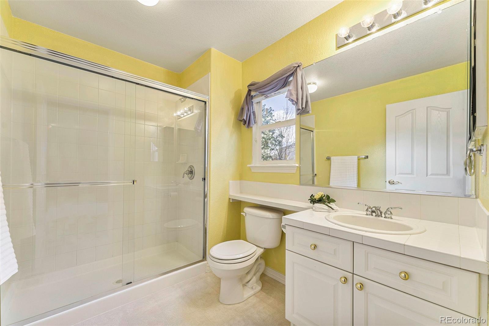 3042 Wyecliff Way Highlands Ranch, CO 80126 - Photo 25 of 40 a bathroom with a sink a toilet and shower