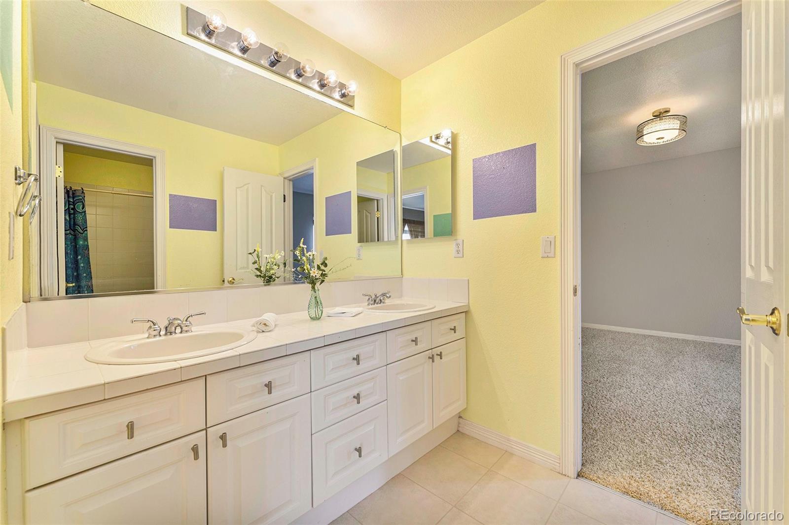 3042 Wyecliff Way Highlands Ranch, CO 80126 - Photo 26 of 40 a bathroom with a double vanity sink mirror and double