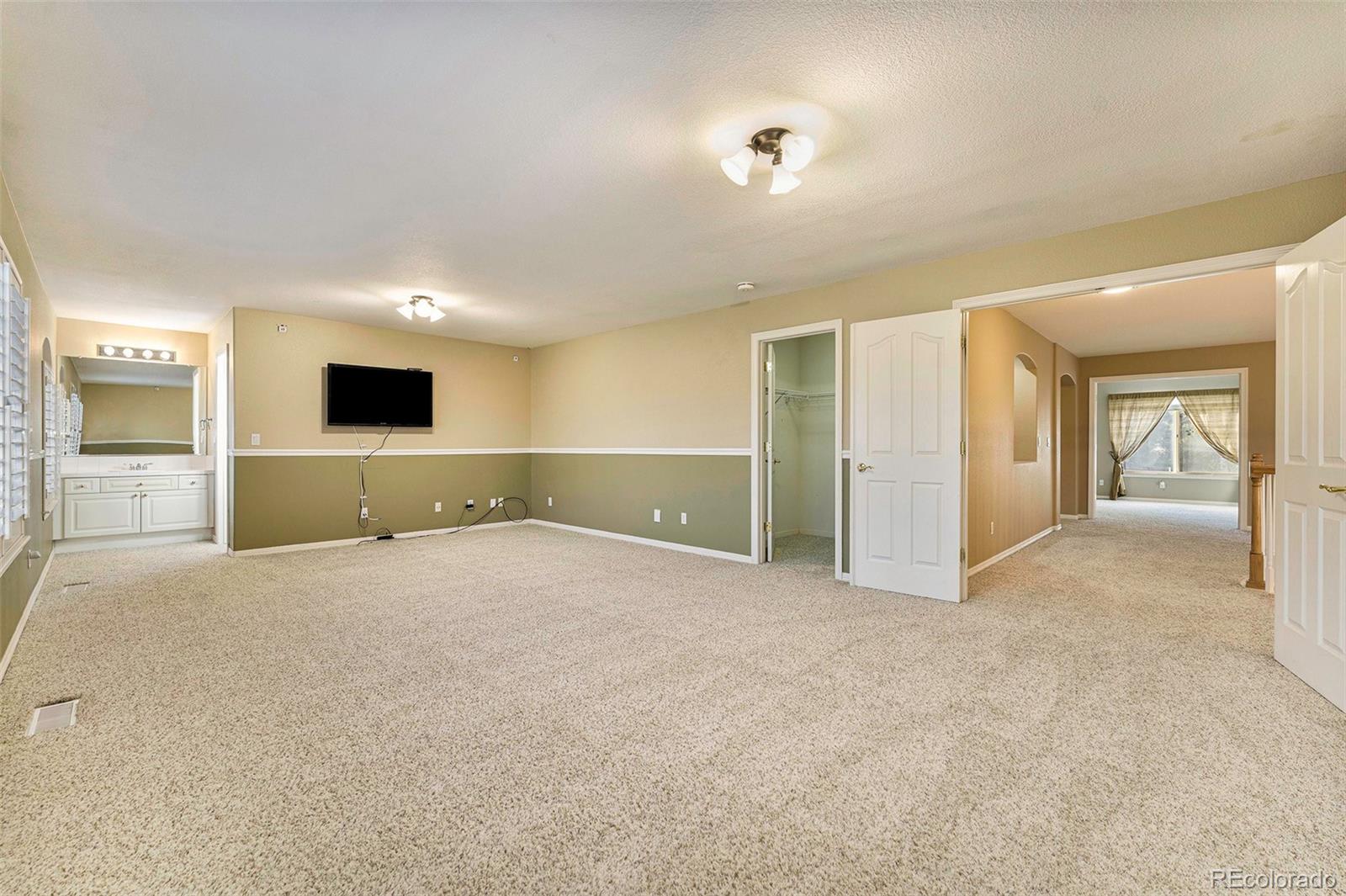 3042 Wyecliff Way Highlands Ranch, CO 80126 - Photo 27 of 40 a view of an empty room and a kitchen