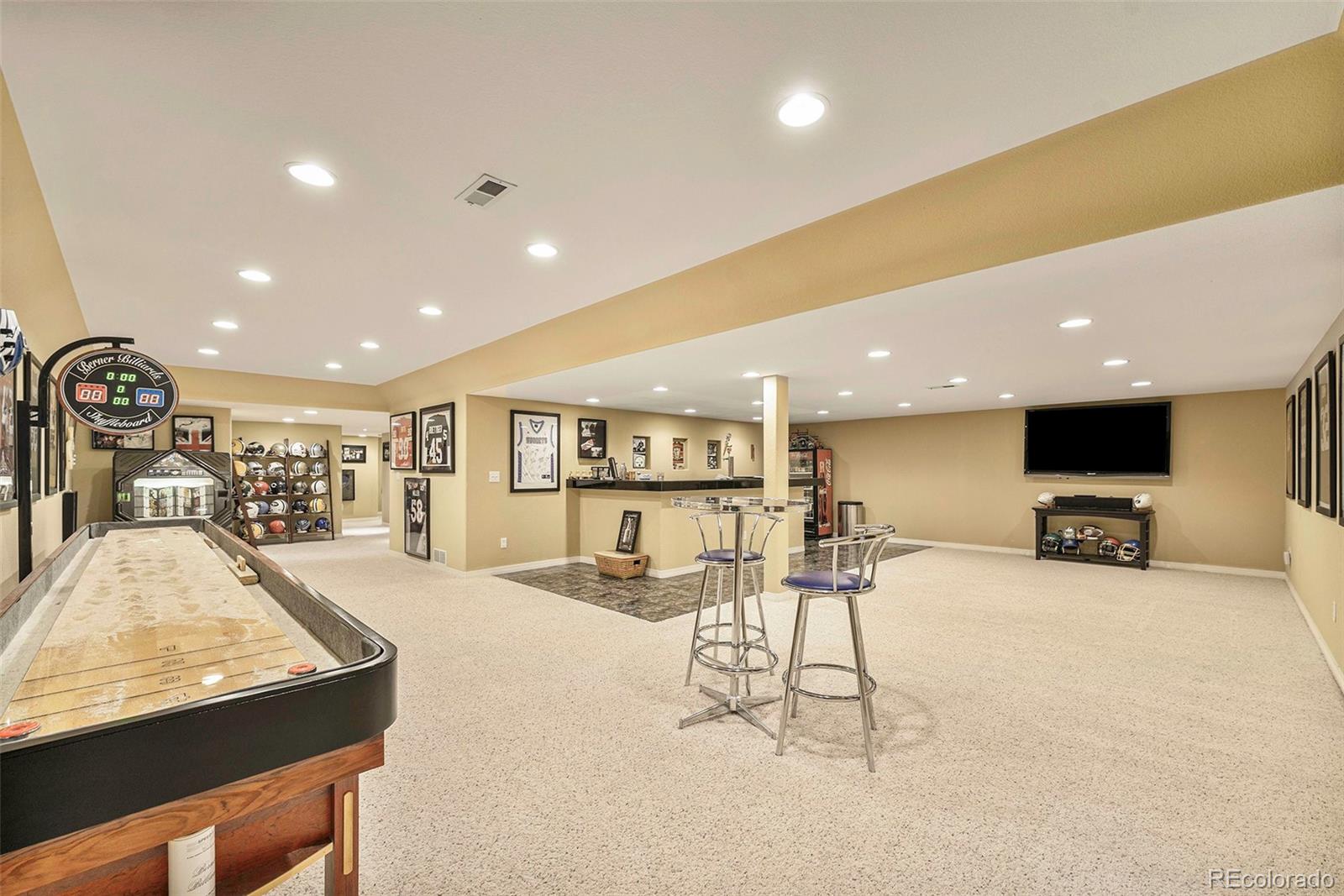 3042 Wyecliff Way Highlands Ranch, CO 80126 - Photo 31 of 40 a living room with stainless steel appliances furniture a flat screen tv and kitchen view