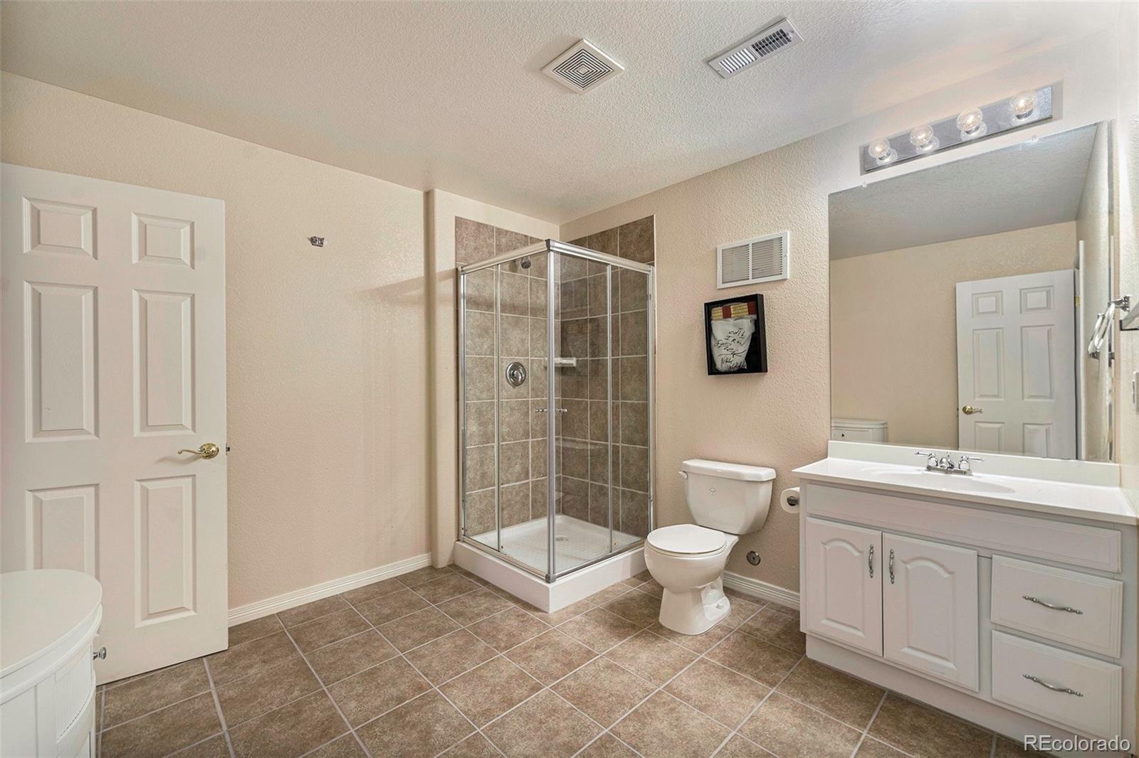 3042 Wyecliff Way Highlands Ranch, CO 80126 - Photo 33 of 40 a bathroom with a toilet sink and shower