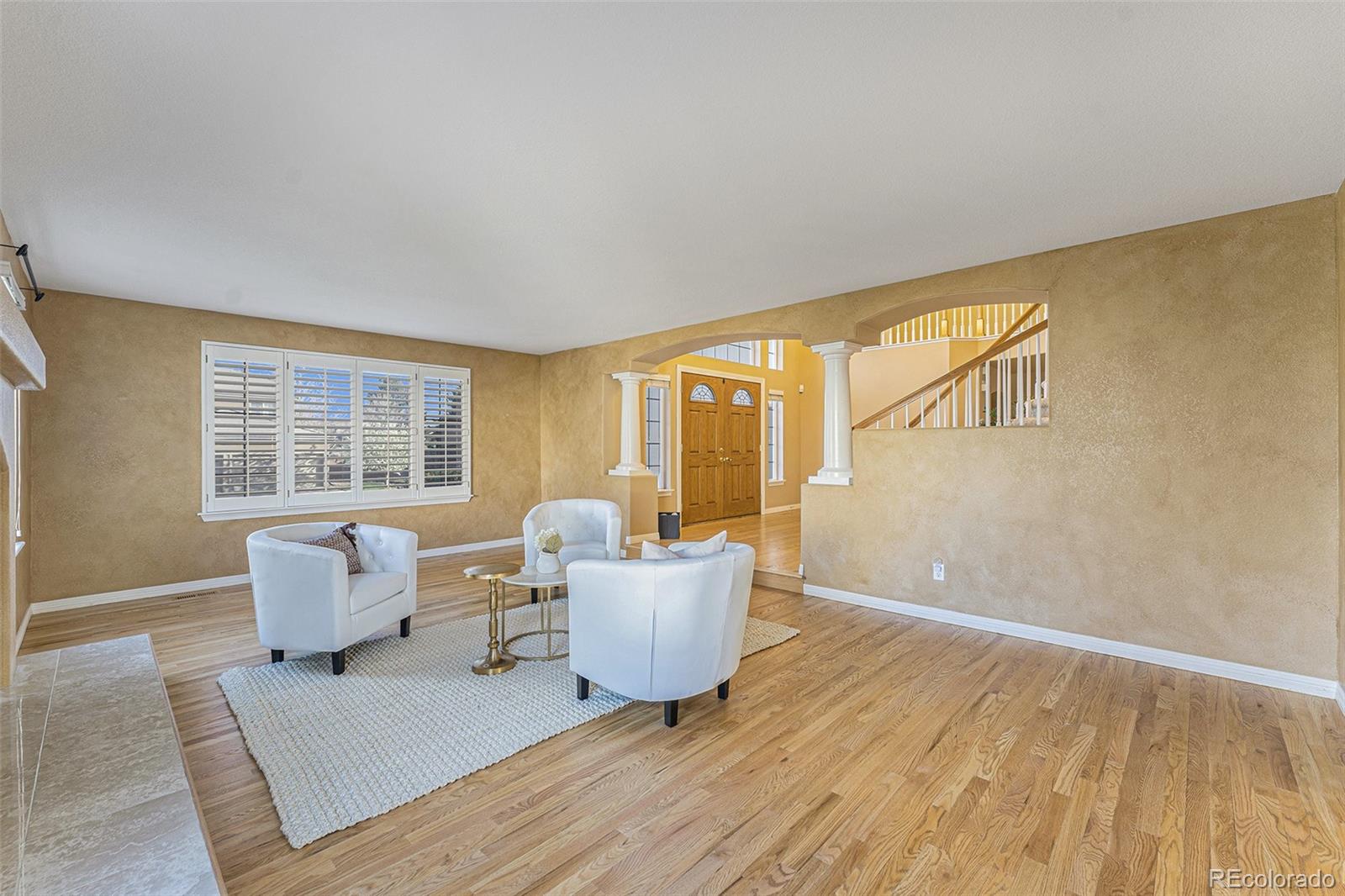 3042 Wyecliff Way Highlands Ranch, CO 80126 - Photo 4 of 40 a living room with furniture and wooden floor