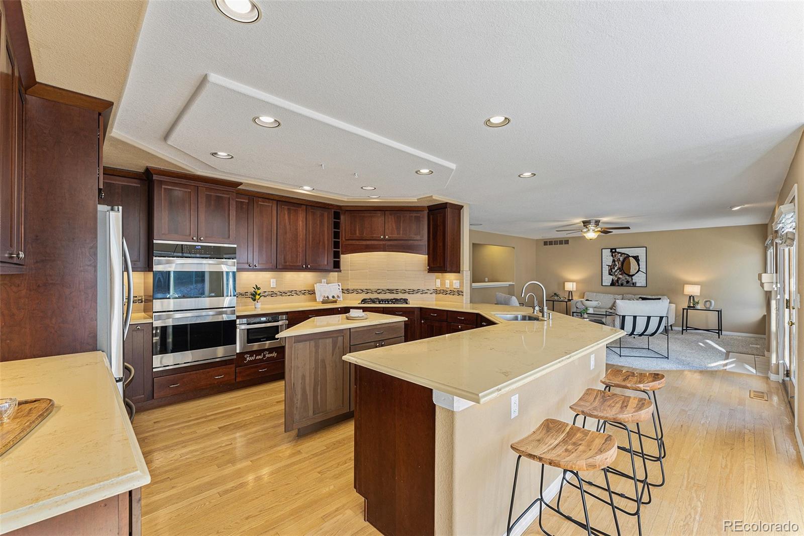 3042 Wyecliff Way Highlands Ranch, CO 80126 - Photo 7 of 40 a large kitchen with a large counter top appliances and cabinets