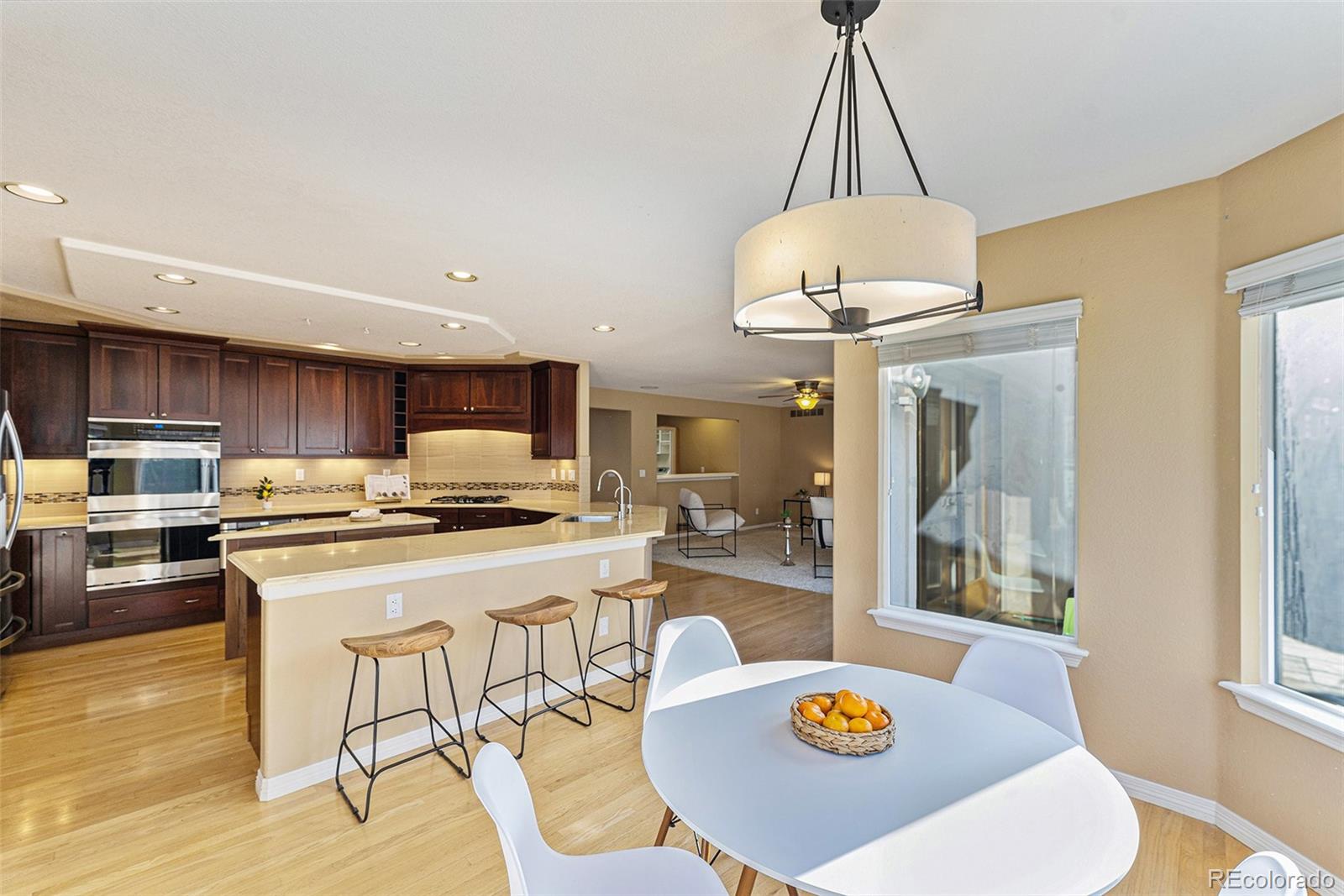 3042 Wyecliff Way Highlands Ranch, CO 80126 - Photo 8 of 40 a kitchen with a dining table and chairs