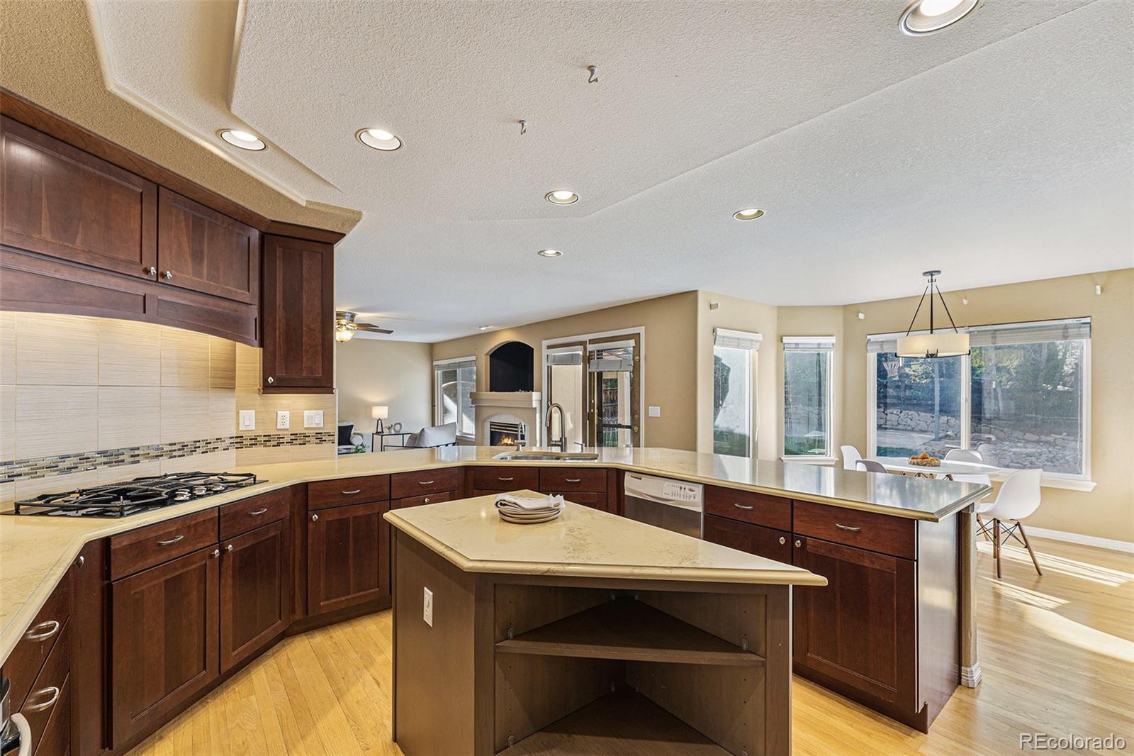 3042 Wyecliff Way Highlands Ranch, CO 80126 - Photo 9 of 40 a kitchen with a stove a sink a refrigerator and wooden cabinets