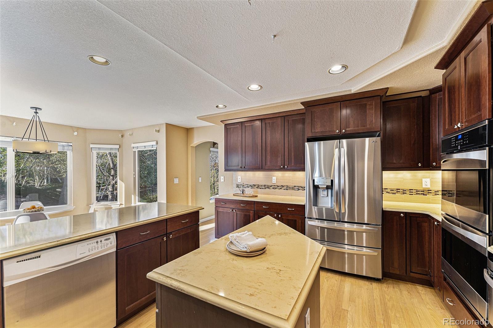 3042 Wyecliff Way Highlands Ranch, CO 80126 - Photo 10 of 40 a kitchen with refrigerator cabinets and a counter top space