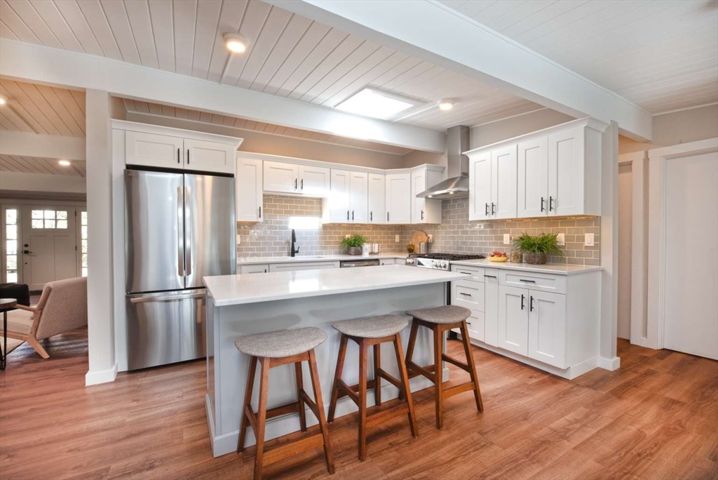 160 Oxbow Road Wayland, MA 01778 - Photo 5 of 19 a kitchen with stainless steel appliances granite countertop a refrigerator a stove microwave and white cabinets