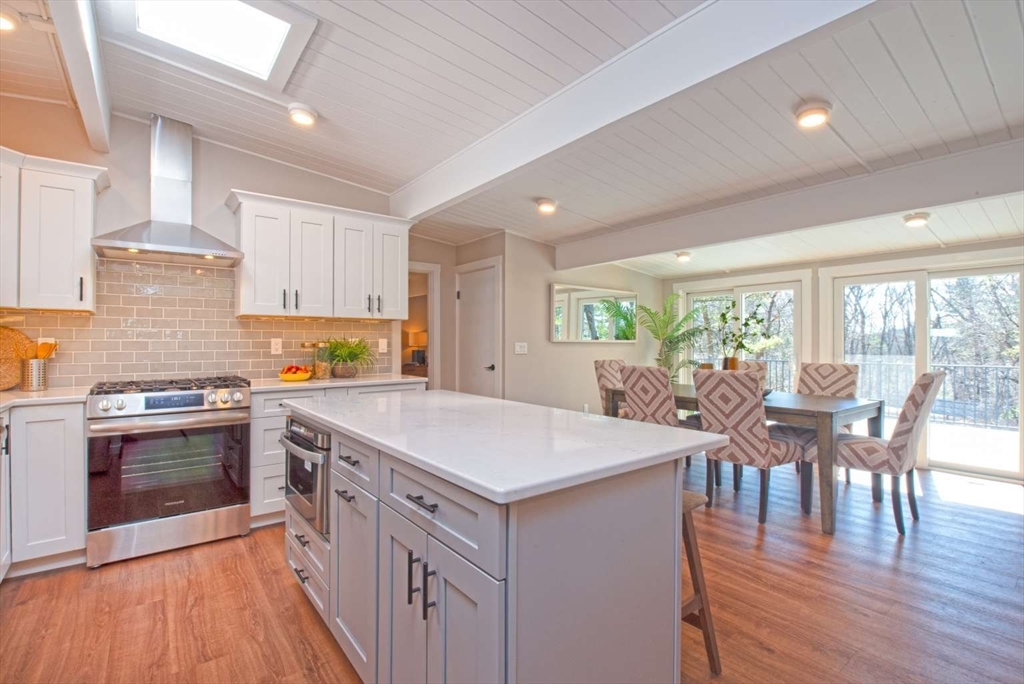 160 Oxbow Road Wayland, MA 01778 - Photo 6 of 19 a kitchen with a table chairs stove and wooden floor