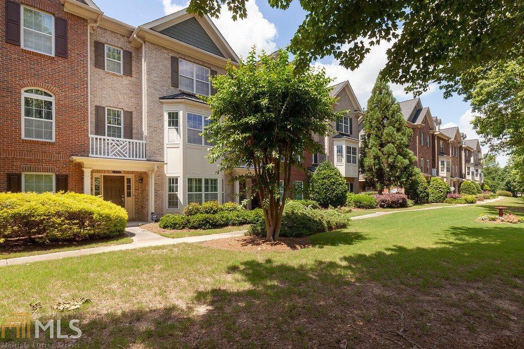 1434 Ruffner Lane Lawrenceville, GA 30043 - Photo 1 of 1 a front view of a building with garden