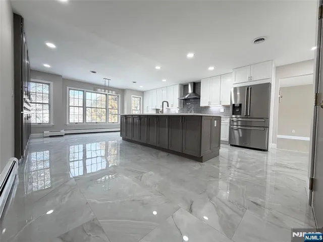 a kitchen with refrigerator and window